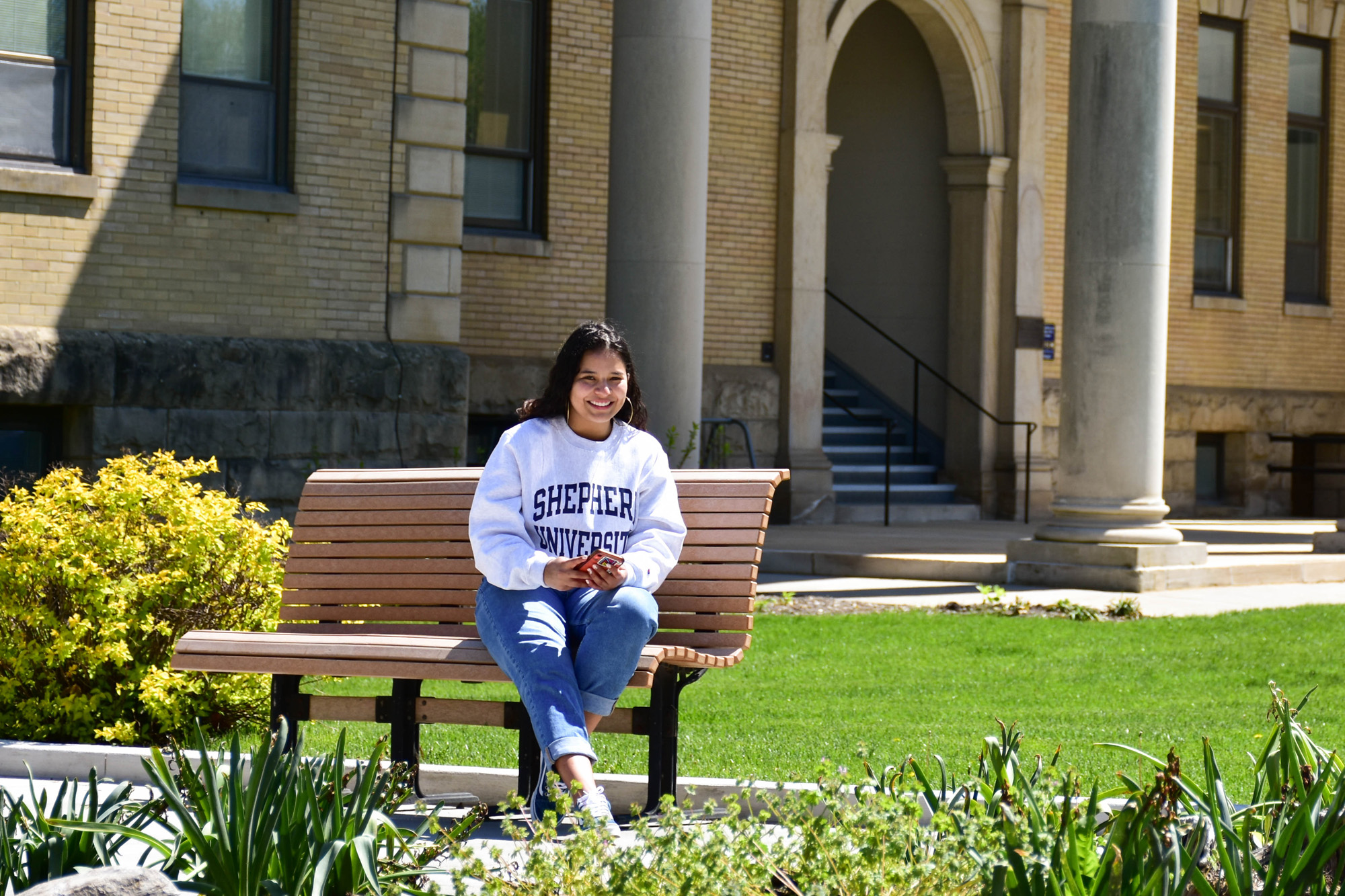 Student on bench outside.
