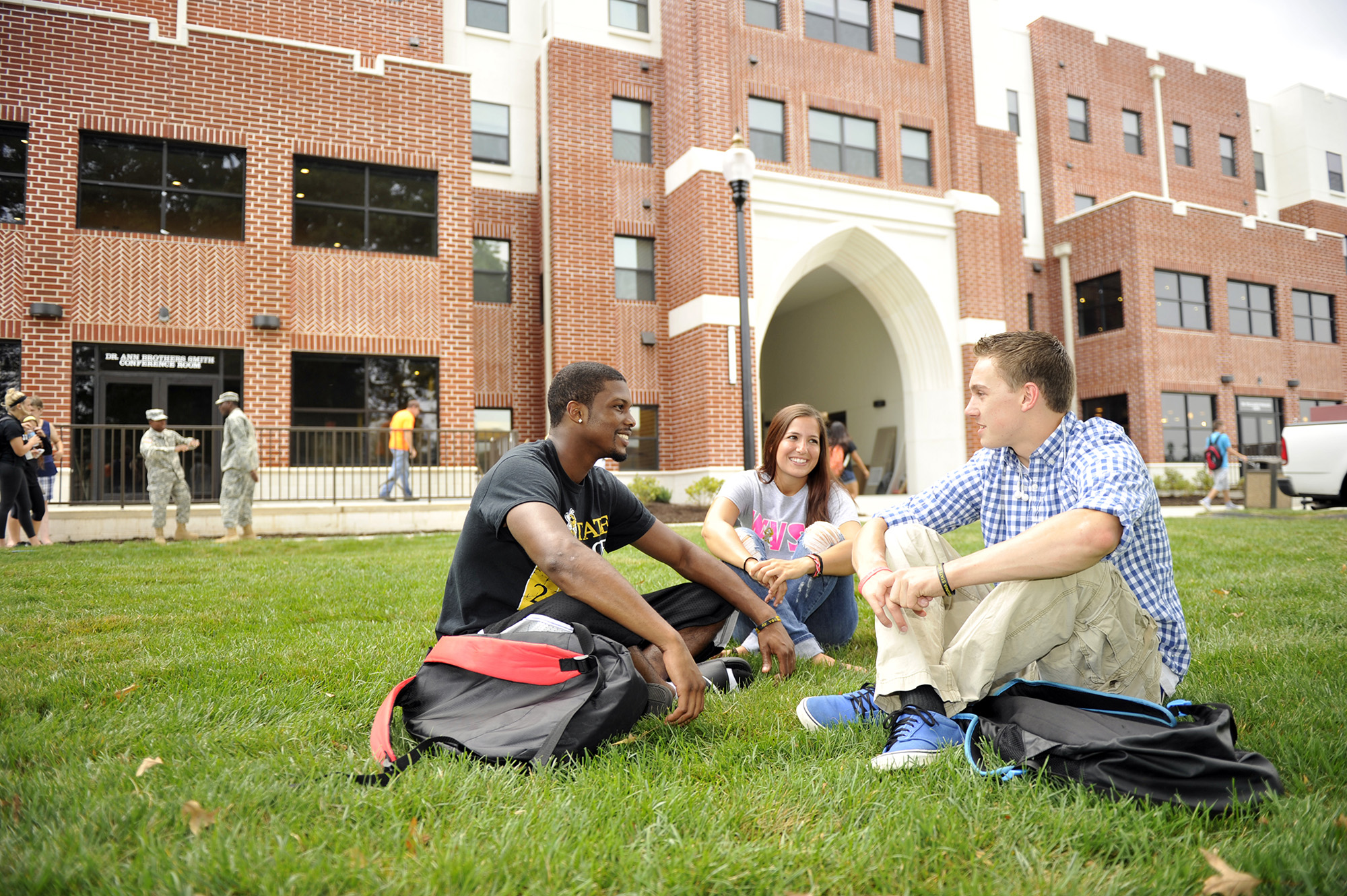Students sitting on lawn.